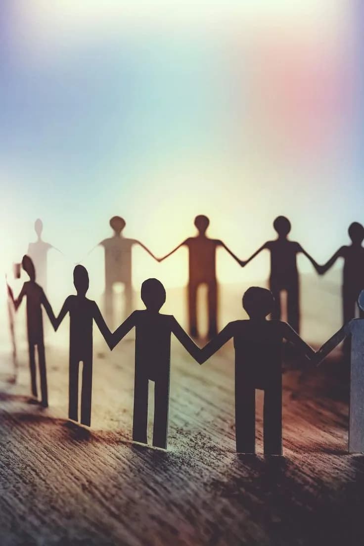 Silhouettes holding hands in a circle