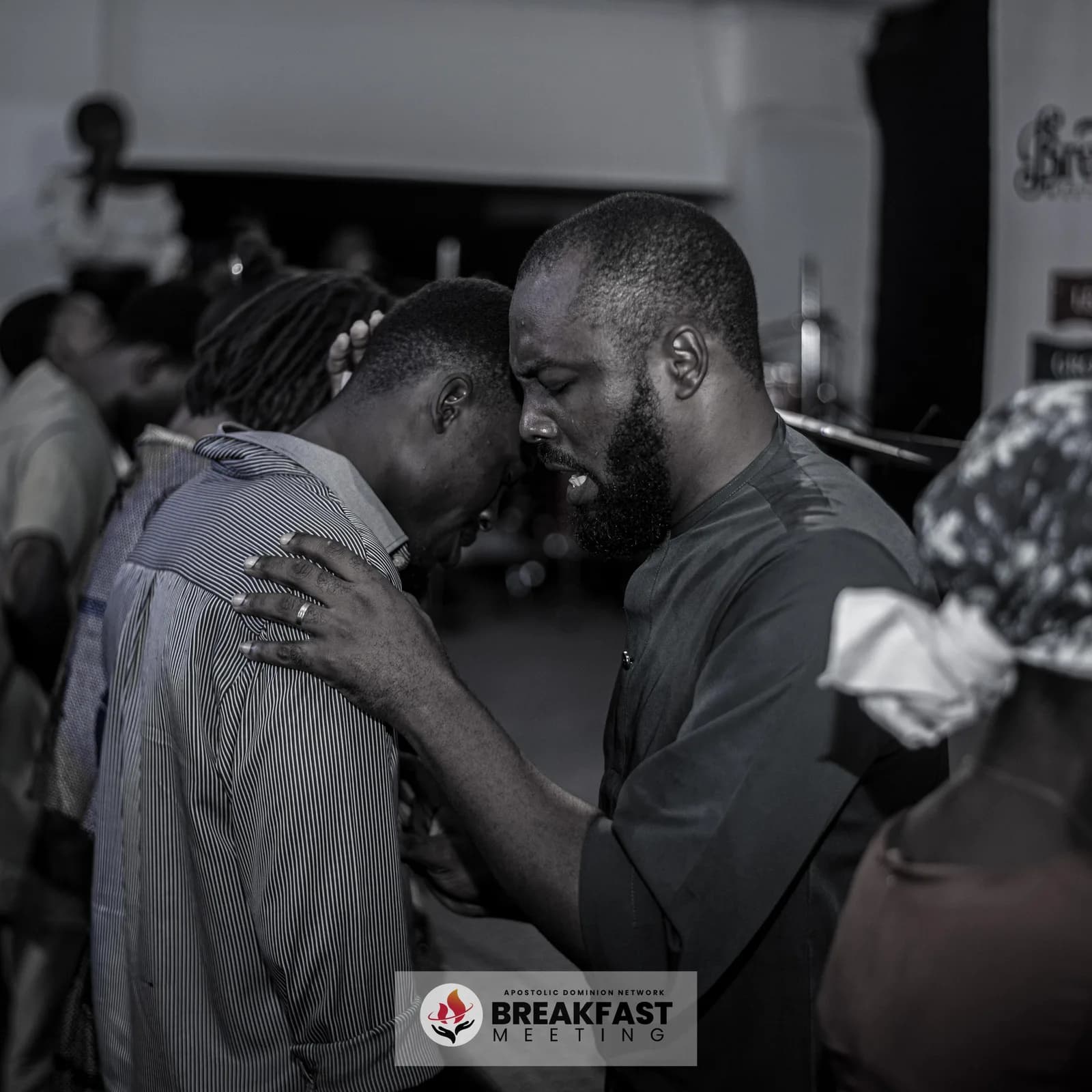 Two men embracing in prayer