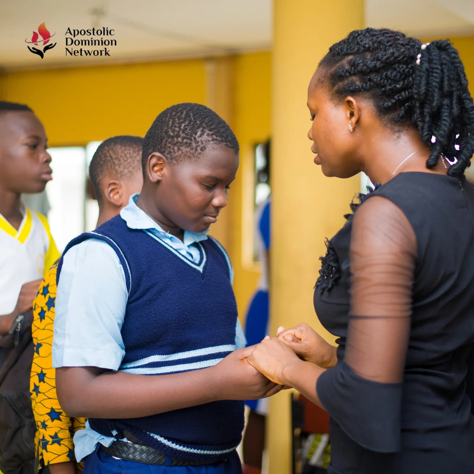 Young woman praying with a student