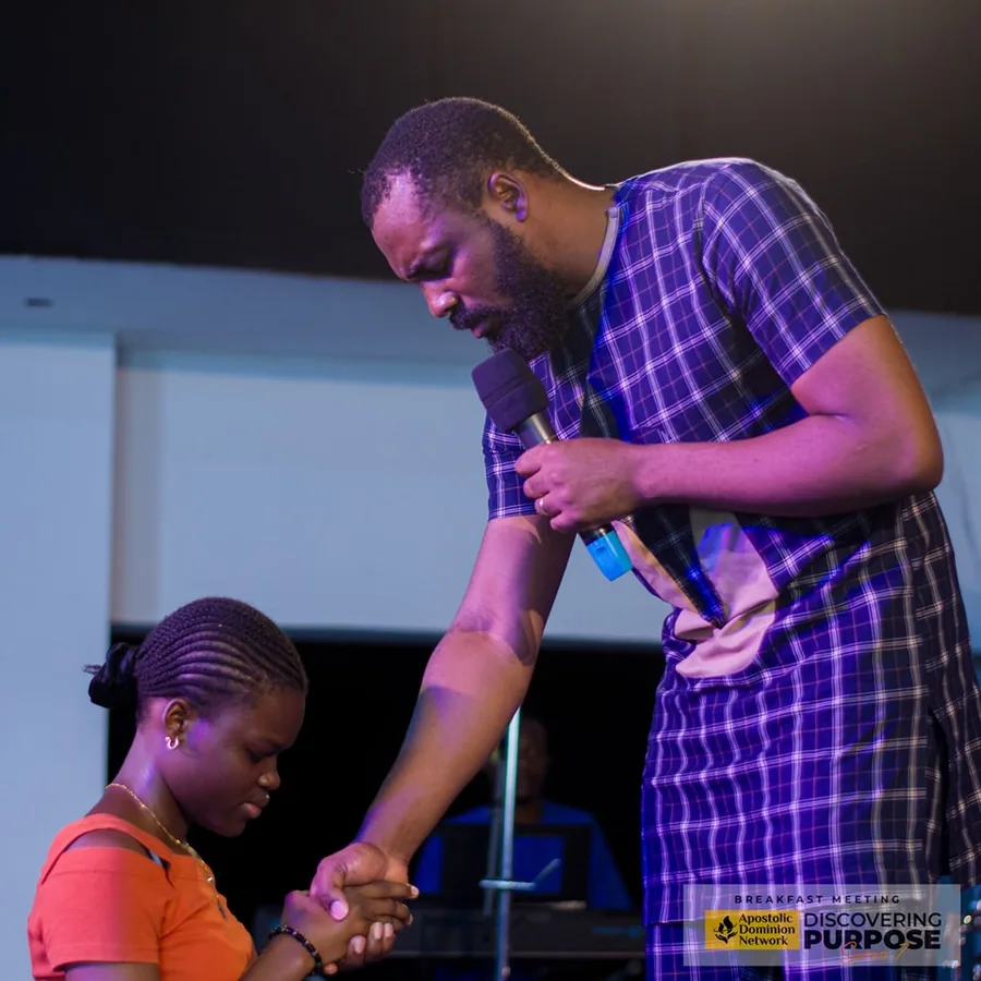 Pastor ministering to a child at outreach